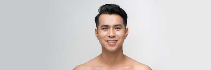 Beauty portrait of shirtless handsome Asian male model smiling for men skin care concept