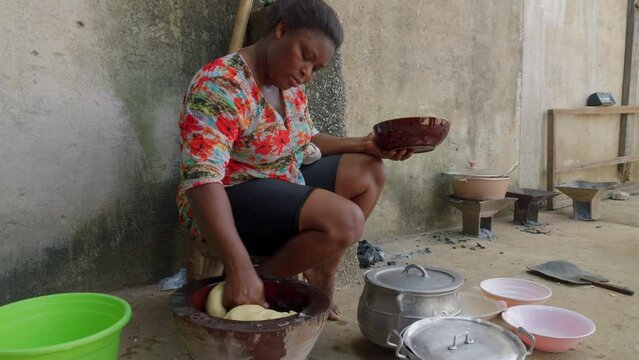 black African woman preparing fufu traditional street food in west africa, expert skilled African chef 