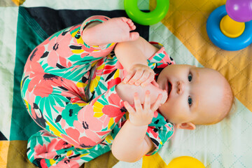 Portrait of a cute baby girl playing with a toy at home