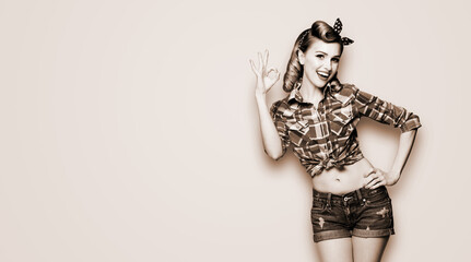Pin up girl. Portrait photo of excited cheerful smiling woman showing ok okay hand sign gesture....