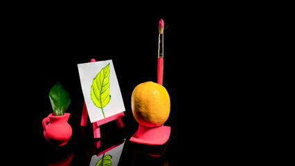 Composition with lemon at the easel on a black background