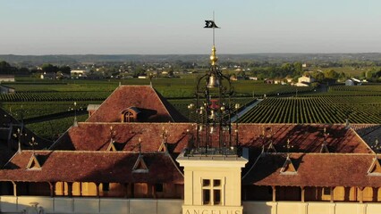 Drone flying over Chateau Angelus winery with vineyards in background, Saint-Emilion in France. Aerial drone view