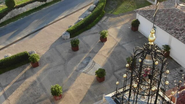 Details of bell tower and courtyard in Chateau Angelus winery at Saint-Emilion in France. Aerial top-down orbiting