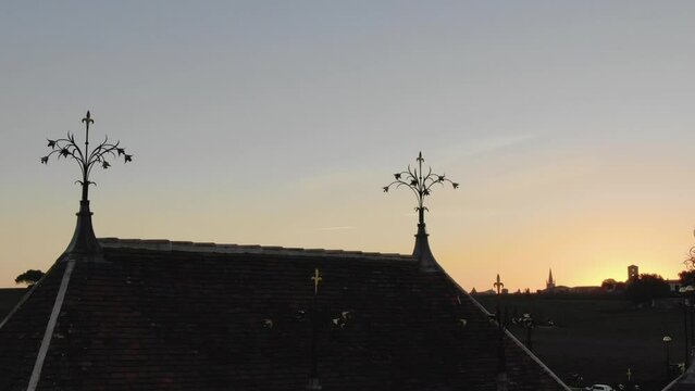 Architectural and decorative details on roof of Chateau Angelus winery at dusk, Saint-Emilion in France. Aerial drone view and sky for copy space