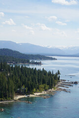 View of Lake Tahoe's east shore and rocky coves from the top of Cave Rock on a sunny day  