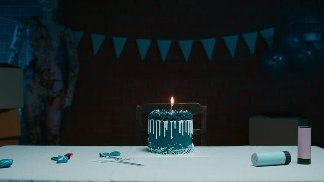Blue birthday cake on the table with one candle