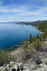 View of Lake Tahoe's east shore and rocky coves from the top of Cave Rock on a sunny day  