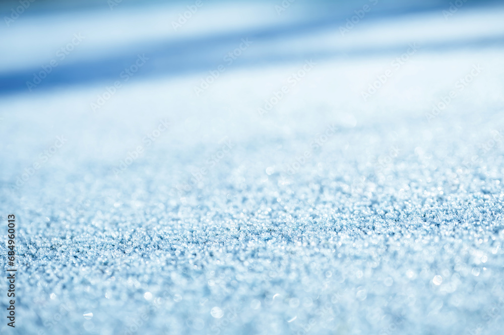 Poster snow surface selective focus. winter background with snow texture and beautiful blurry bokeh light, 