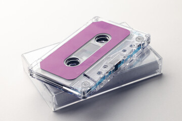 Close up of purple cassette tape and white box on white background