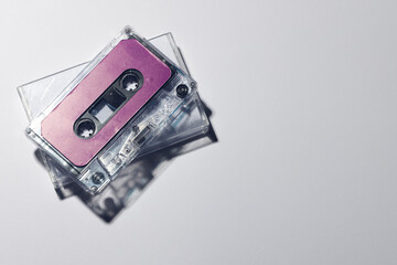 Overhead view of purple cassette tape and white box with copy space on white background