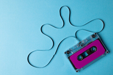 Overhead view of purple cassette tape with copy space on blue background