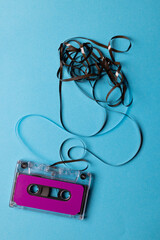Overhead view of purple cassette tape with copy space on blue background
