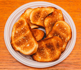 Bread fried in a toaster on a wooden table