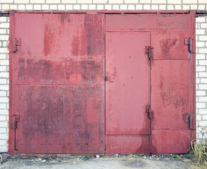 Old metal red gate in the garage