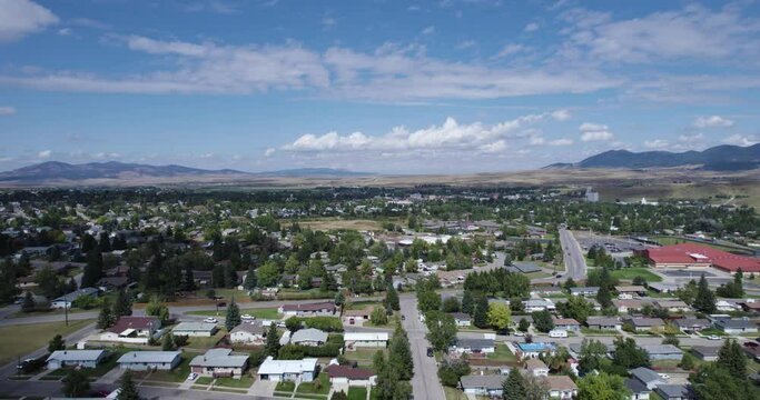 Aerial view over Lewistown city neighborhood area and mountains in background