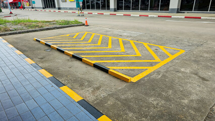 Yellow diagonal stripes between parallel lines painted on a paved road. Yellow diagonal stripes on road. Traffic Signal Objects diagonal yellow stripes painted on streets.