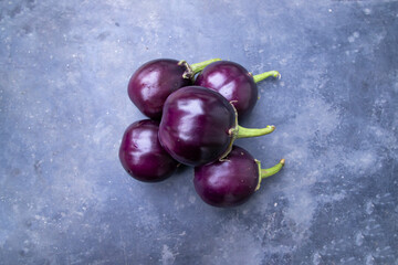 Fresh eggplant on a black concrete floor top view. Agricultural concept, cultivated vegetables
