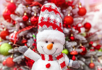 snowman on the background of a Christmas tree
