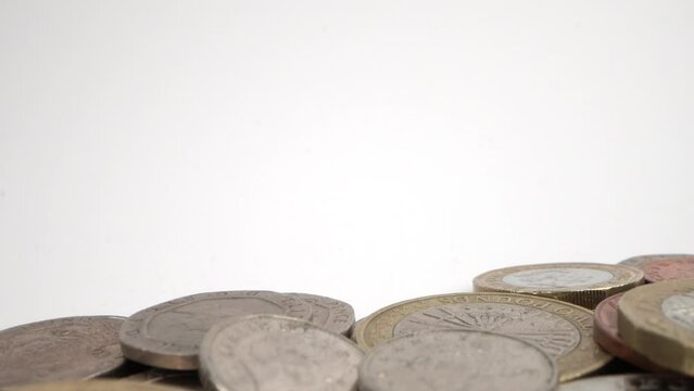 Pile of Circulated UK Coins on White backdrop. Probe lens macro shot