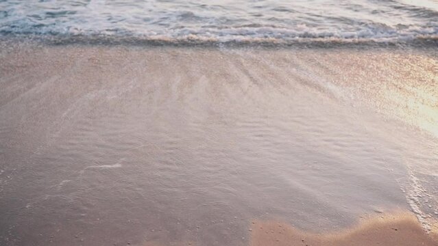 Sunset Tide on Sandy Beach