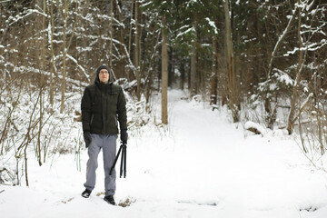 Bearded man in the winter woods. Attractive happy young man with beard walk in the park.