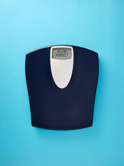 Digital bathroom scale with the message you're perfect on blue background.