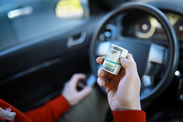 dollars with a car key lie in inside cars. financial concept