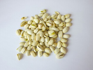 Pile of Pistachios isolated on white background. Pistachios closeup for your design and print. Nuts collection