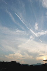 Fototapeta na wymiar vanilla sky background and chemtrail