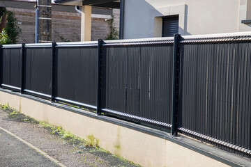 barrier wooden fender wall gey steel fence of suburb house facade - obrazy, fototapety, plakaty