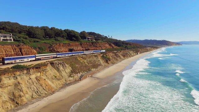 Train Travels Along Bluffs In Del Mar, San Diego, California, USA - aerial drone shot