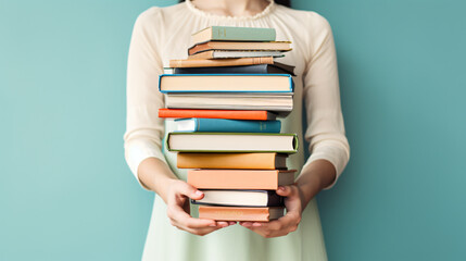 Woman hands holding pile of books