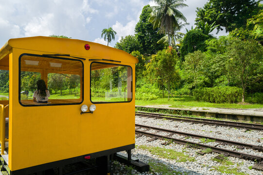 Little girl standing in the yellow retro train cart
