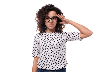 young confident curly secretary woman with glasses is dressed in a blouse on a white background with copy space