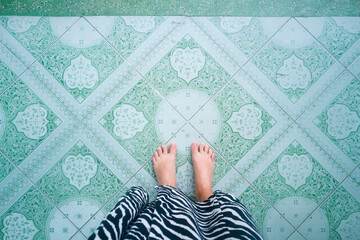 Personal perspective woman standing on the tiles in the Wat Langka temple in Phnom Penh
