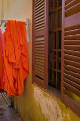 Orange Buddhist monks clothing hanging down in the pagoda