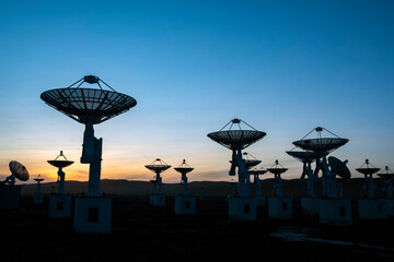 The silhouette of a radio telescope