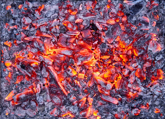 Top view of red hot smoldering coals from a fire