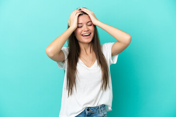 Young caucasian woman isolated on blue background laughing