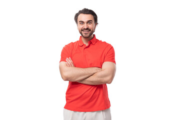 Fototapeta premium young funny smart man with black hair and beard dressed in a red t-shirt on a white background with copy space