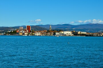 Naklejka na ściany i meble View of the town of Koper at the coast of the Adriatic sea and hill in the background