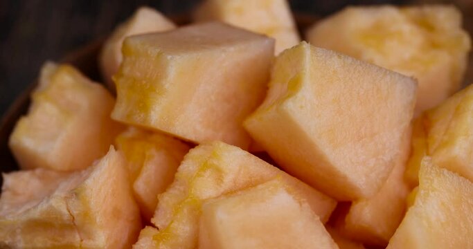sliced orange melon close-up, delicious soft and ripe food melon on the table