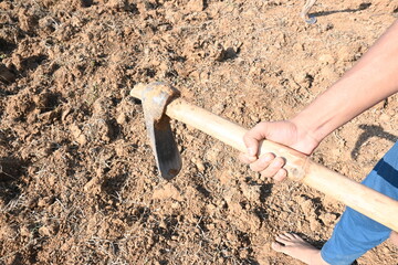 Farmer digging the field. Soil preparation for planting. The farmer working his farm and preparing...