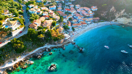 Drone Aerial view of little village at Greek island: Tropical blue sea water , cliffs and colorful...