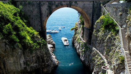Aerial view of Fjord of Furore, Amalfi coast in Italy . Azure waters embrace the rugged cliff - obrazy, fototapety, plakaty