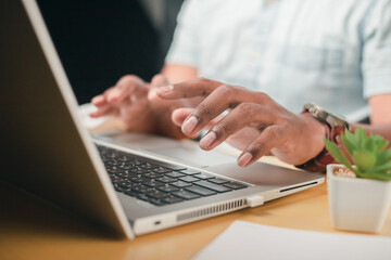 A business man is checking daily online stock market prices through a laptop at home with graphs displayed on the screen. Concept of daily business uncle	
