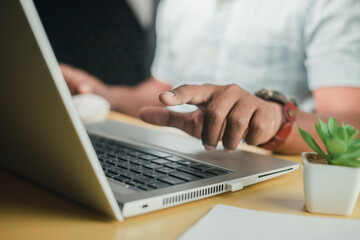 A business man is checking daily online stock market prices through a laptop at home with graphs displayed on the screen. Concept of daily business uncle	