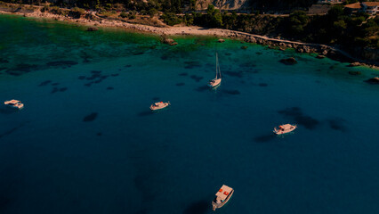 Coastal aerial view of little boats in blue sea water