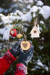 Bird food. Woman feeds birds in winter. 