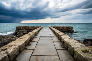 Another depiction of a stone walkway in the sea, accompanied by benches and set against a backdrop of stormy clouds in the sky.